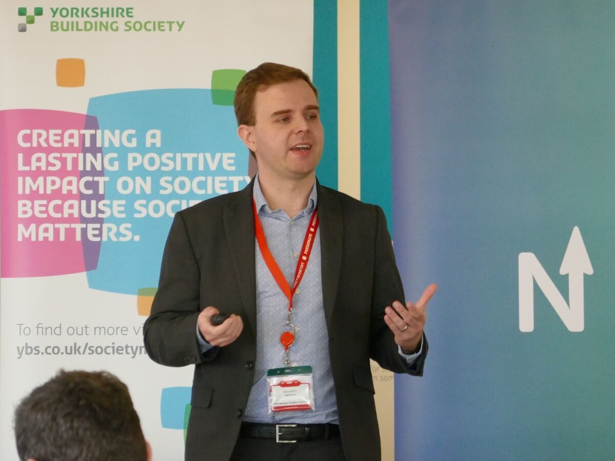 Simon Worgan speaking at Fintech North in front of a Yorkshire Building Society banner