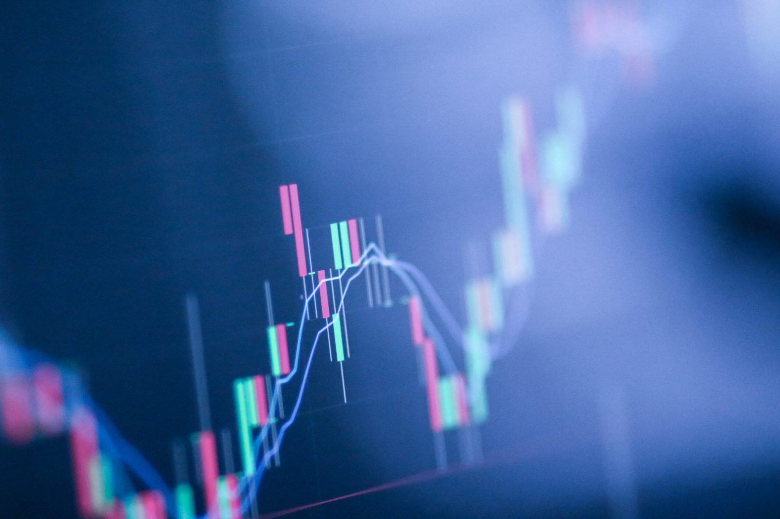 Close-up of a red and green candlestick stock chart on a blue LED display