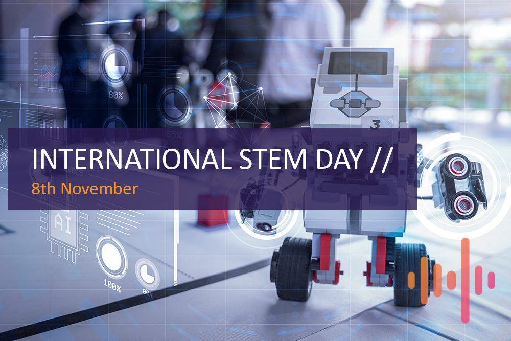 Toy robot built from construction parts with digital overlays, captioned International STEM Day, 8th November