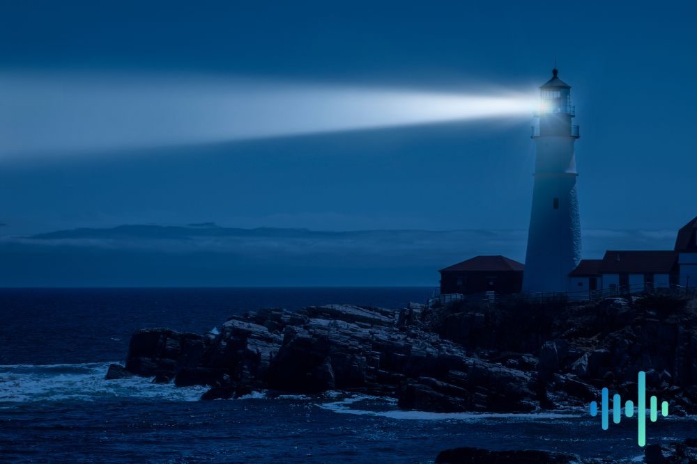 Lighthouse shining its beam across a dark blue sea at dusk from a rocky shore, with a blue and teal waveform