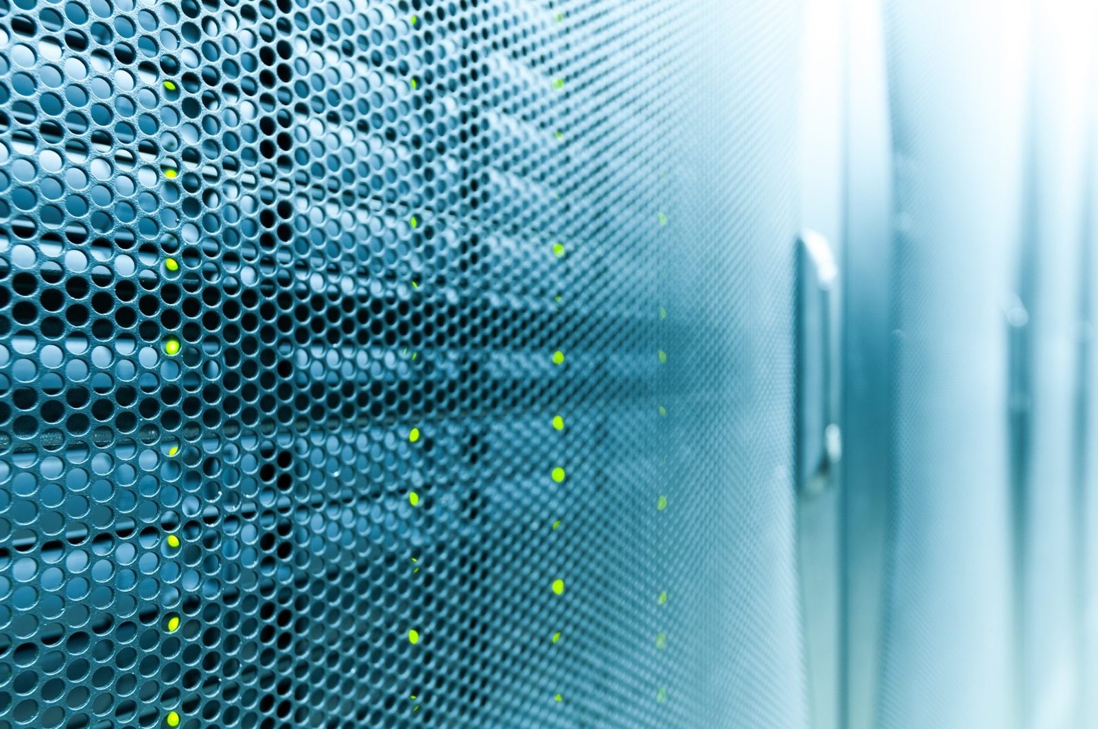 Perforated server cabinet doors with small green indicator lights in a data centre