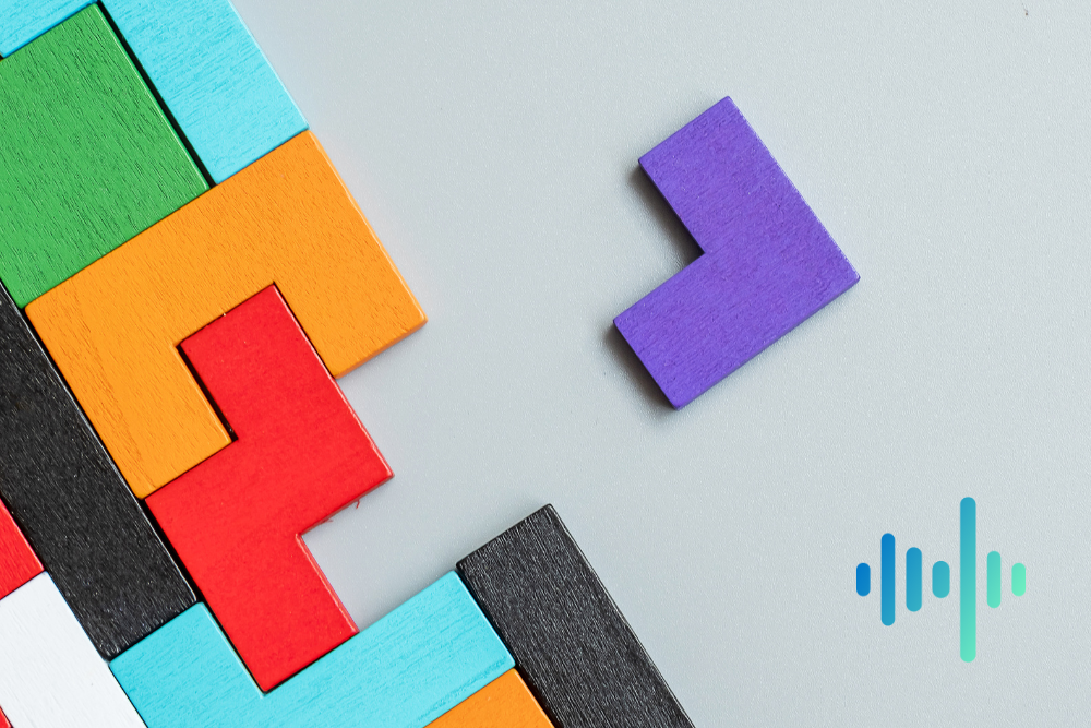 Colourful wooden puzzle blocks fitted together with one purple piece set apart, with a blue and teal waveform