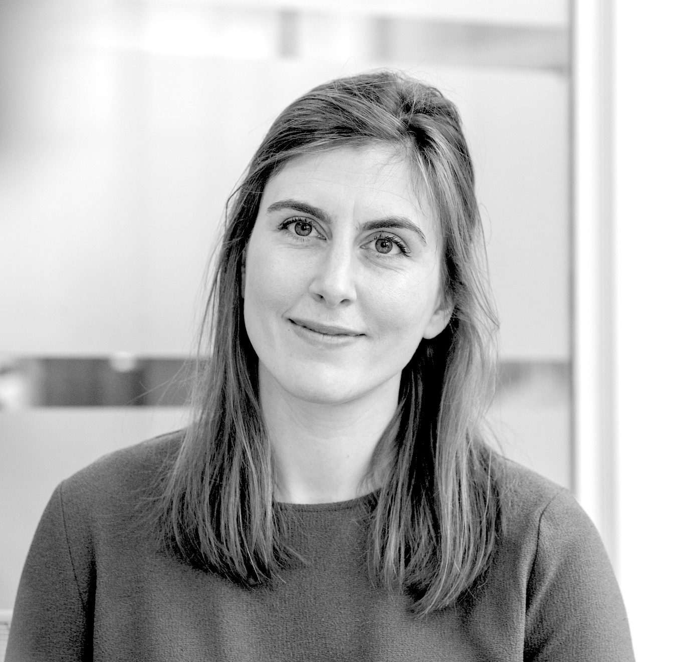Black-and-white portrait of Laura Wathen, Finance Director at Recordsure, smiling with long hair