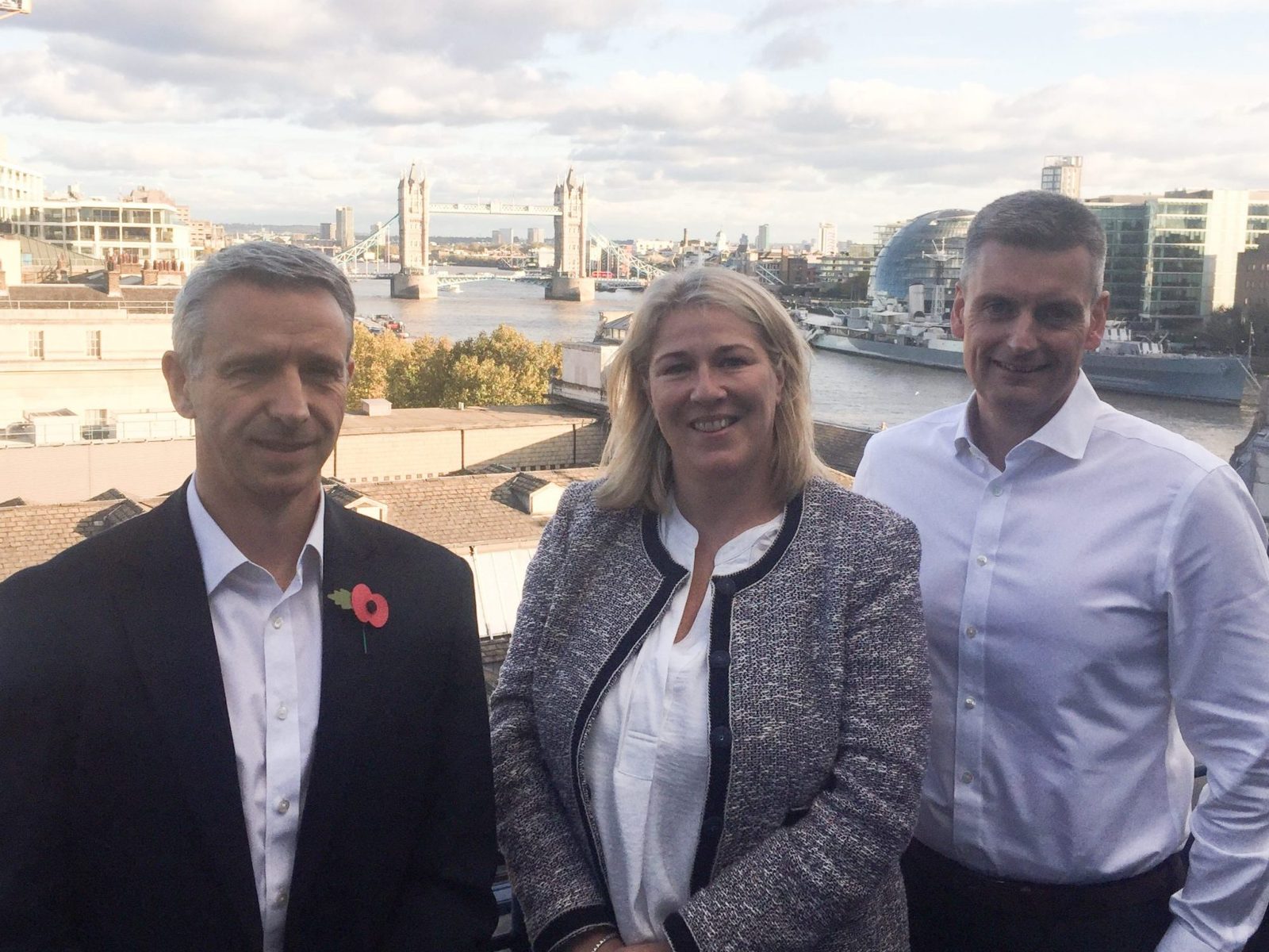 Joanne Smith with new chief executives Joe Norburn and Mike Park on a terrace overlooking Tower Bridge