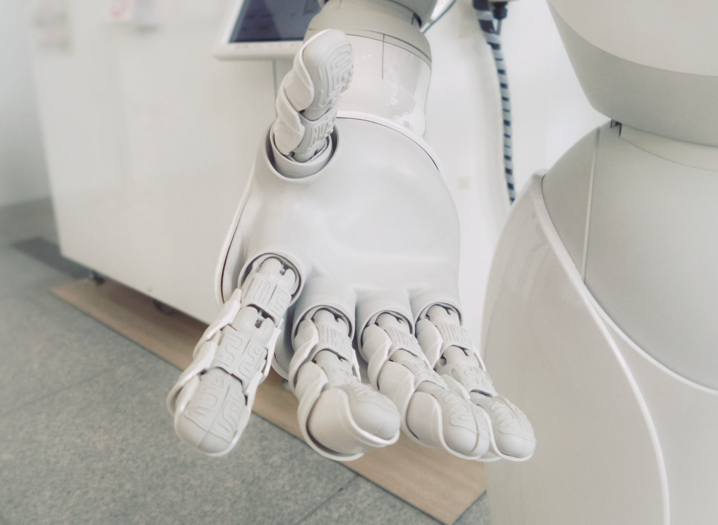 Close-up of a white humanoid robot's outstretched hand and arm