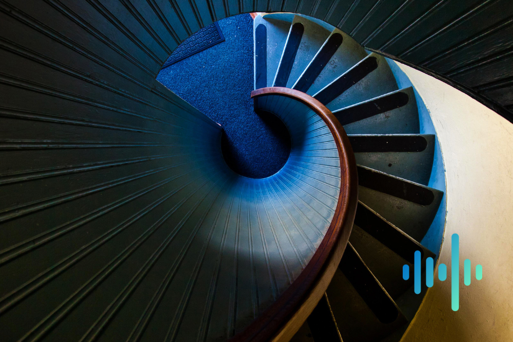 Looking down a spiral staircase with blue-carpeted steps curling into the centre, with a blue and teal waveform