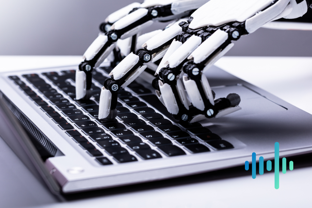 White robotic hands typing on a silver laptop keyboard, with a blue and teal waveform