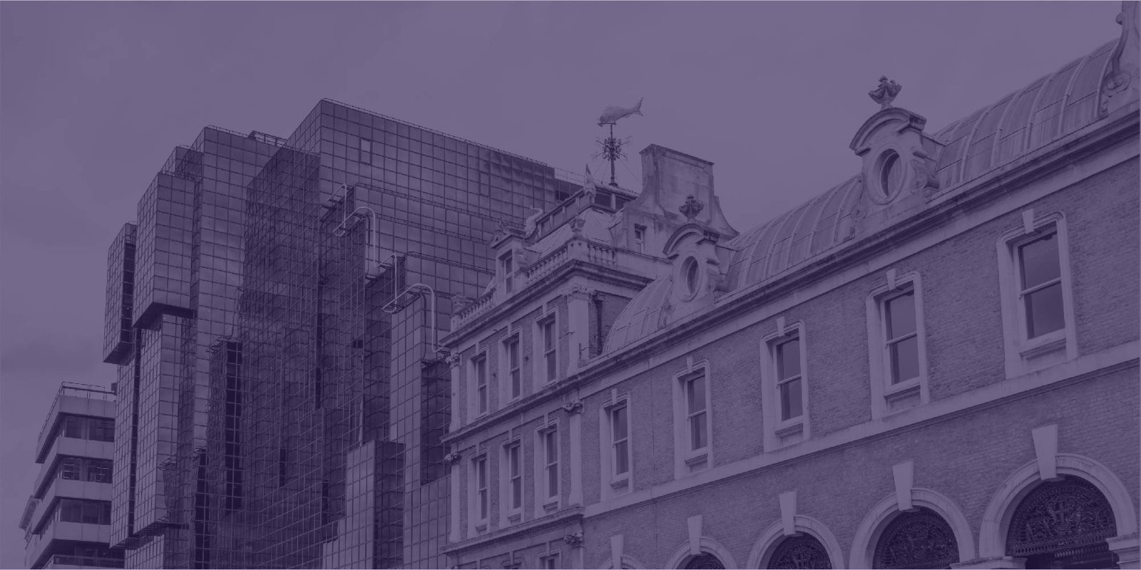 Modern glass office block beside an ornate Victorian building, under a purple tint